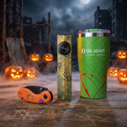 Wasteland Survival Kit on a weathered wood table in a foggy ruined town at night: Olight ArkPro Wasteland Relic flashlight, Kizer Microbe Halloween knife and Olight Zombie Green tumbler, with glowing jack-o'-lanterns and a full moon