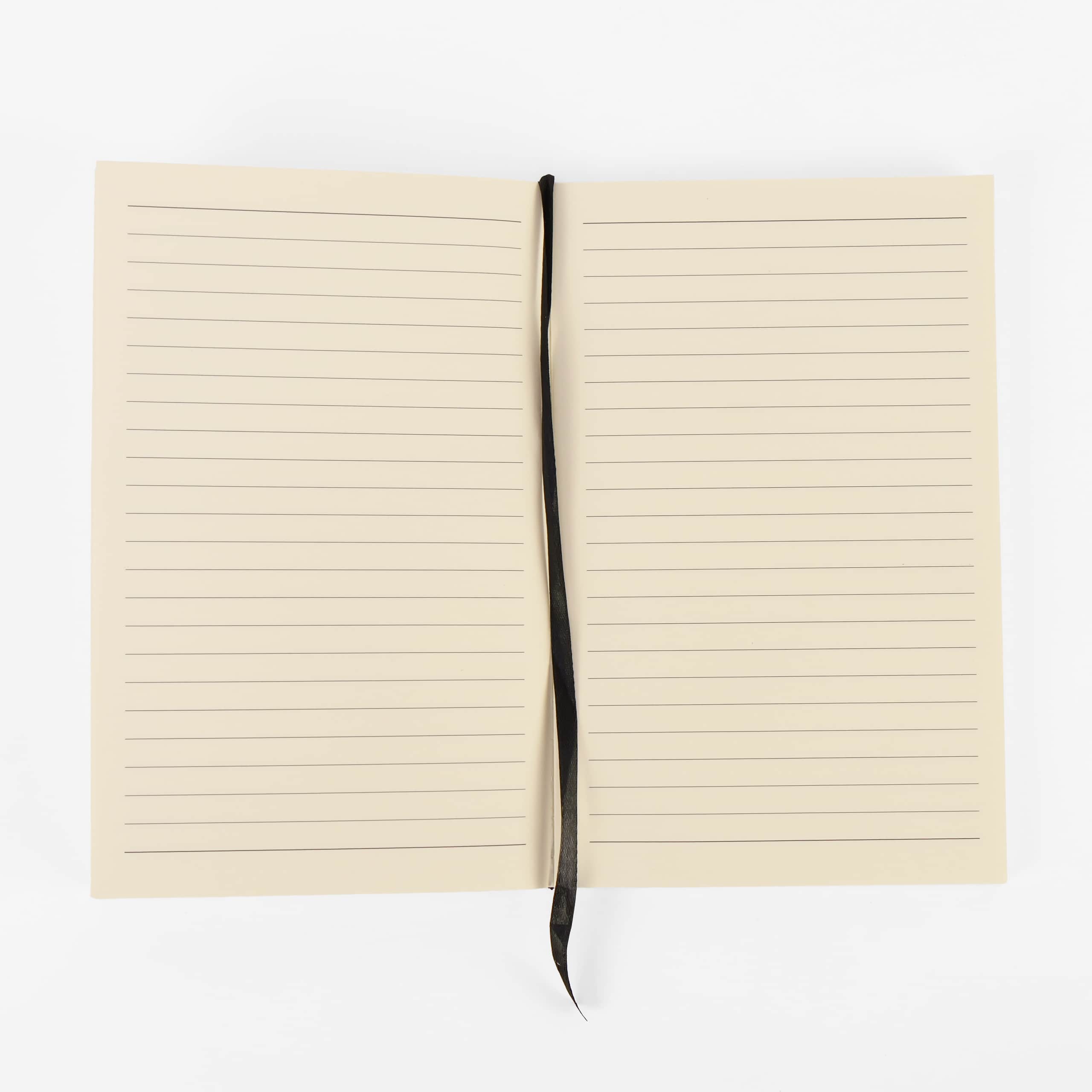 Lined journal refill notebook open flat, showing ruled cream pages and the ribbon bookmark