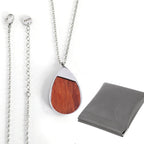 Both engravable faces of a wood inlay pendant necklace in stainless steel — custom engraved wood pendant necklace by Solano Laser Craft