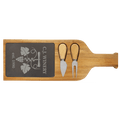 Long slate serving board framed in acacia wood with a serving fork and spreading knife in the front