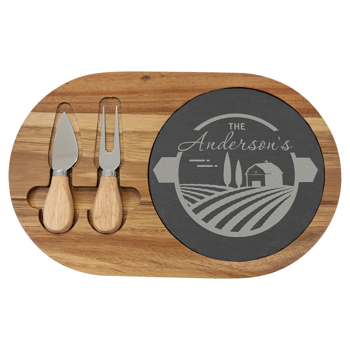 Oval slate cheese board framed in acacia wood with two serving tools set into the front