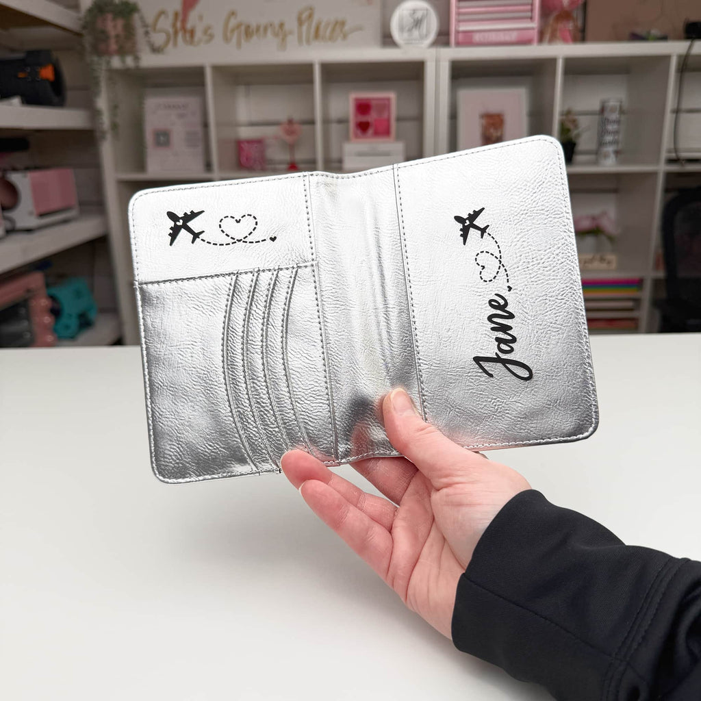 Engraved detail on a leatherette passport wallet showing the contrasting tone beneath the surface — custom engraved passport cover by Solano Laser Craft