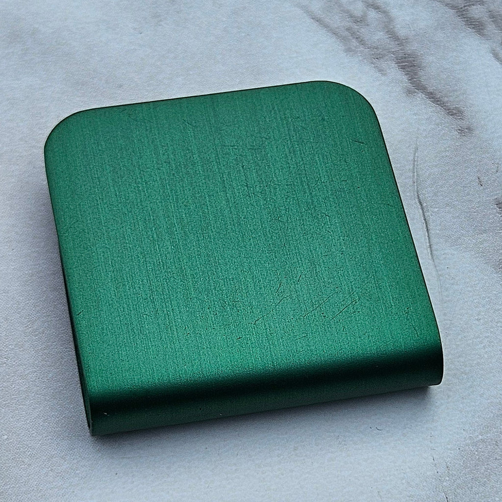 Green magnetic hat clip with a removable golf ball marker