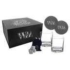 Whiskey gift set engraved with a monogram and a script phrase on the box lid, with engraved glasses, slate coasters and whiskey stones