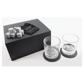 Whiskey gift set engraved with a monogram on the box lid and both rocks glasses, set on slate coasters