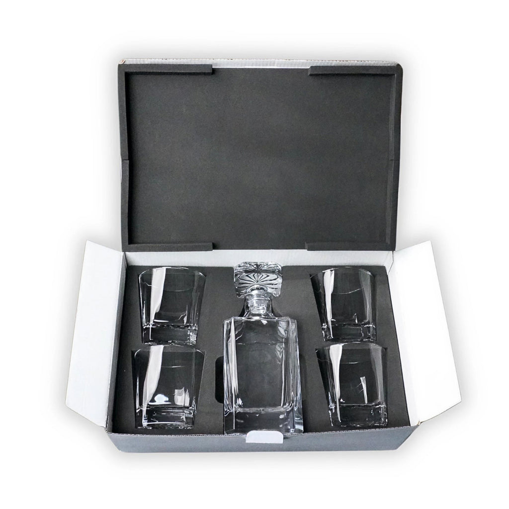 Whiskey decanter with four rocks glasses in a black foam-lined presentation case