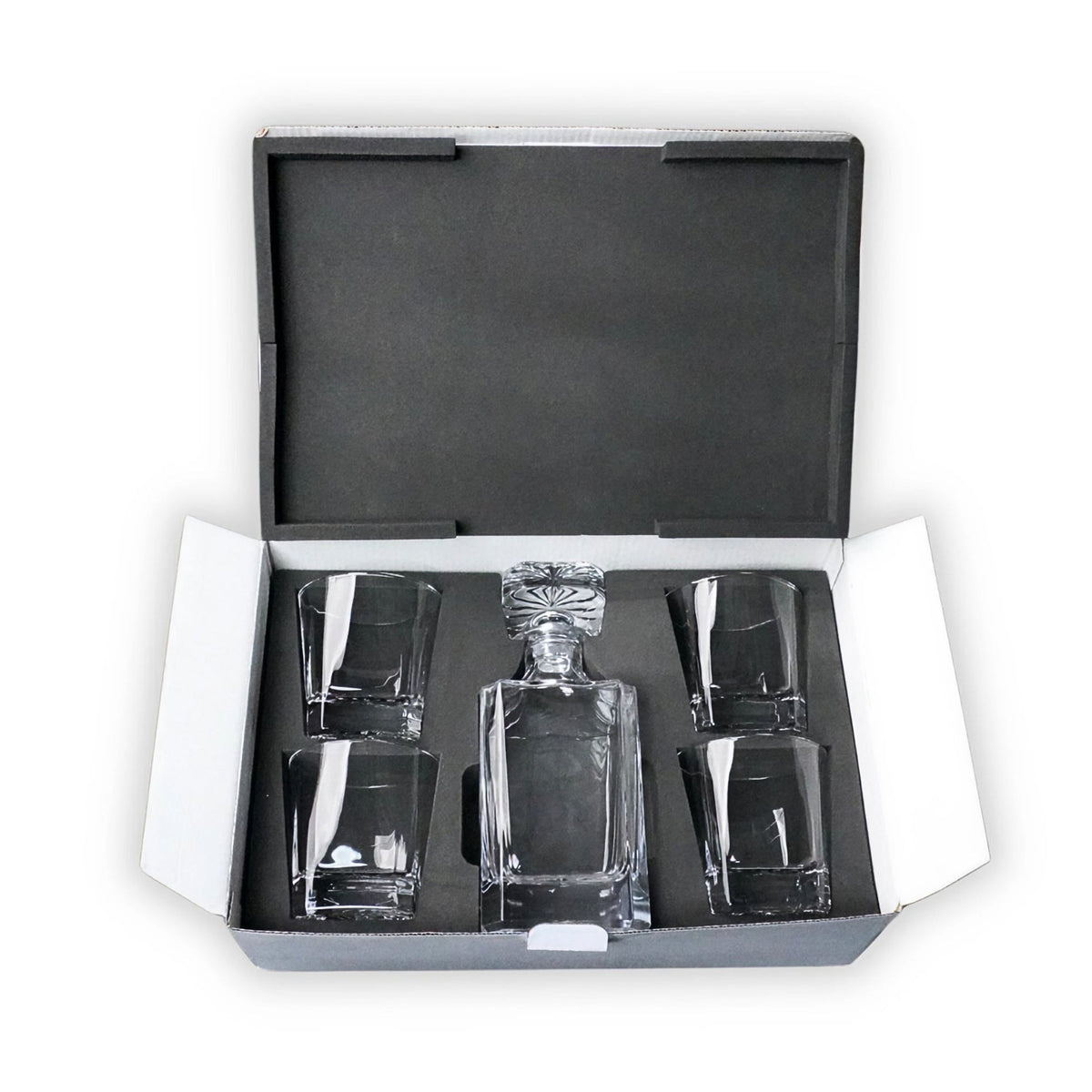 Whiskey decanter with four rocks glasses in a black foam-lined presentation case