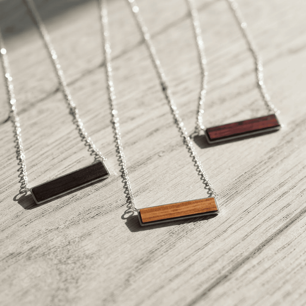 Wood inlay pendant necklaces in stainless steel across seven shapes — custom engraved wood pendant necklace by Solano Laser Craft