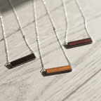 Wood inlay pendant necklaces in stainless steel across seven shapes — custom engraved wood pendant necklace by Solano Laser Craft