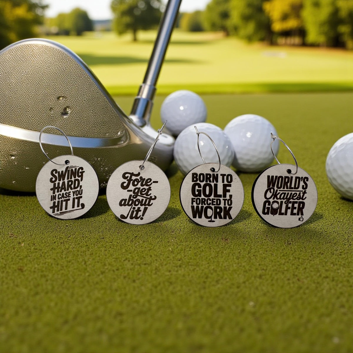Round wooden golf-themed wine charms scattered among golf balls and a club head on the green