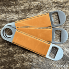 Three stainless steel bar bottle openers wrapped in Buckskin tan Premium Leatherette, fanned out to show the wrap and the opener end.