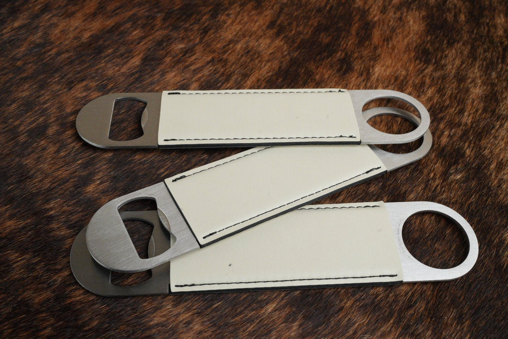 Three stainless steel bar bottle openers wrapped in Eggshell cream Premium Leatherette, fanned out to show the wrap and the opener end.