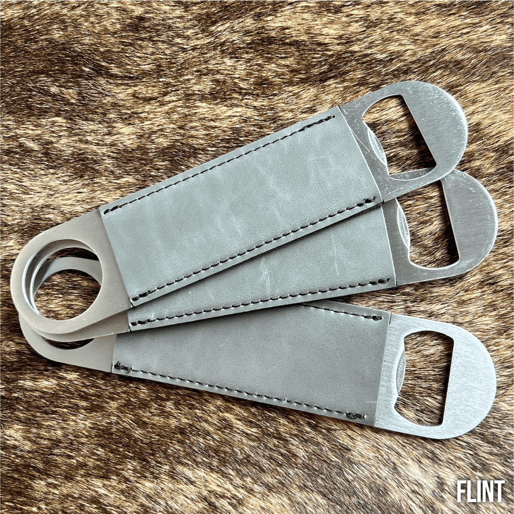Three stainless steel bar bottle openers wrapped in Flint grey Premium Leatherette, fanned out to show the wrap and the opener end.
