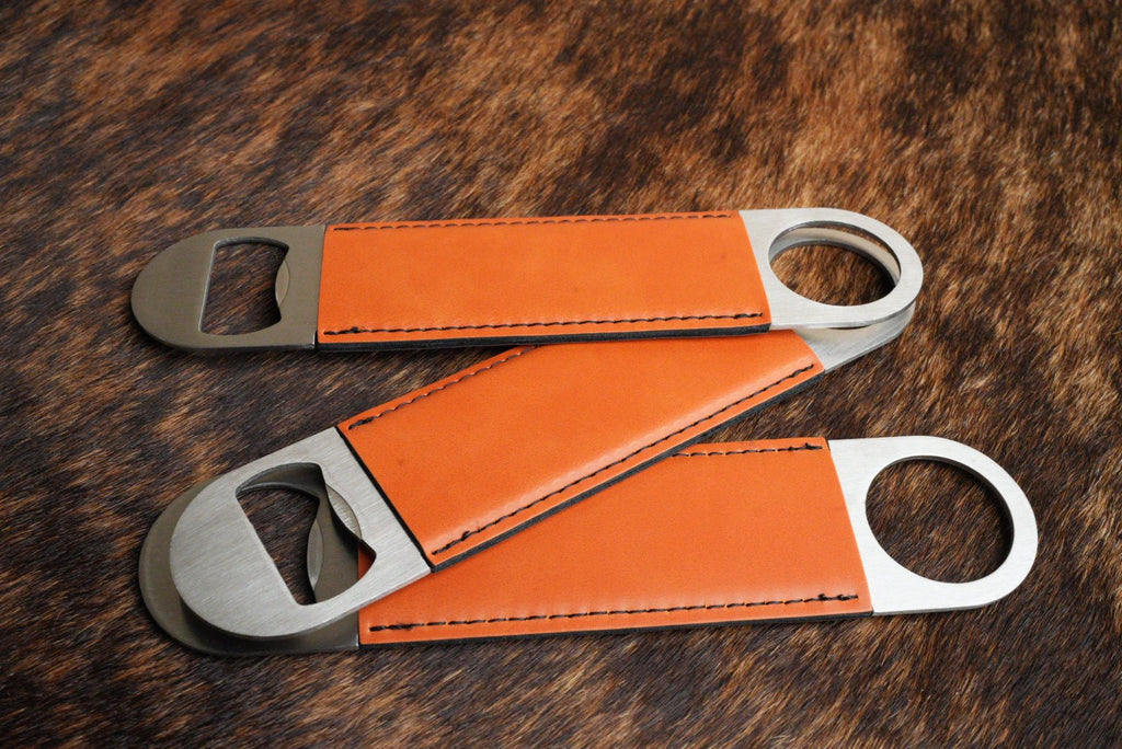 Three stainless steel bar bottle openers wrapped in Orange Premium Leatherette, fanned out to show the wrap and the opener end.