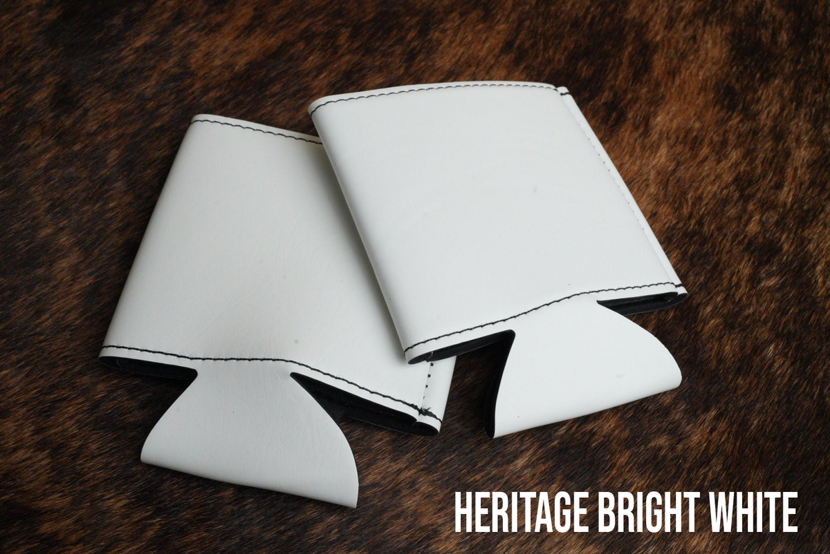 Several Bright White Premium Leatherette can coolers laid flat, shown collapsed.