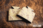 Duck Camo Premium Leatherette can coolers in a waterfowl camouflage pattern, laid flat and collapsed.