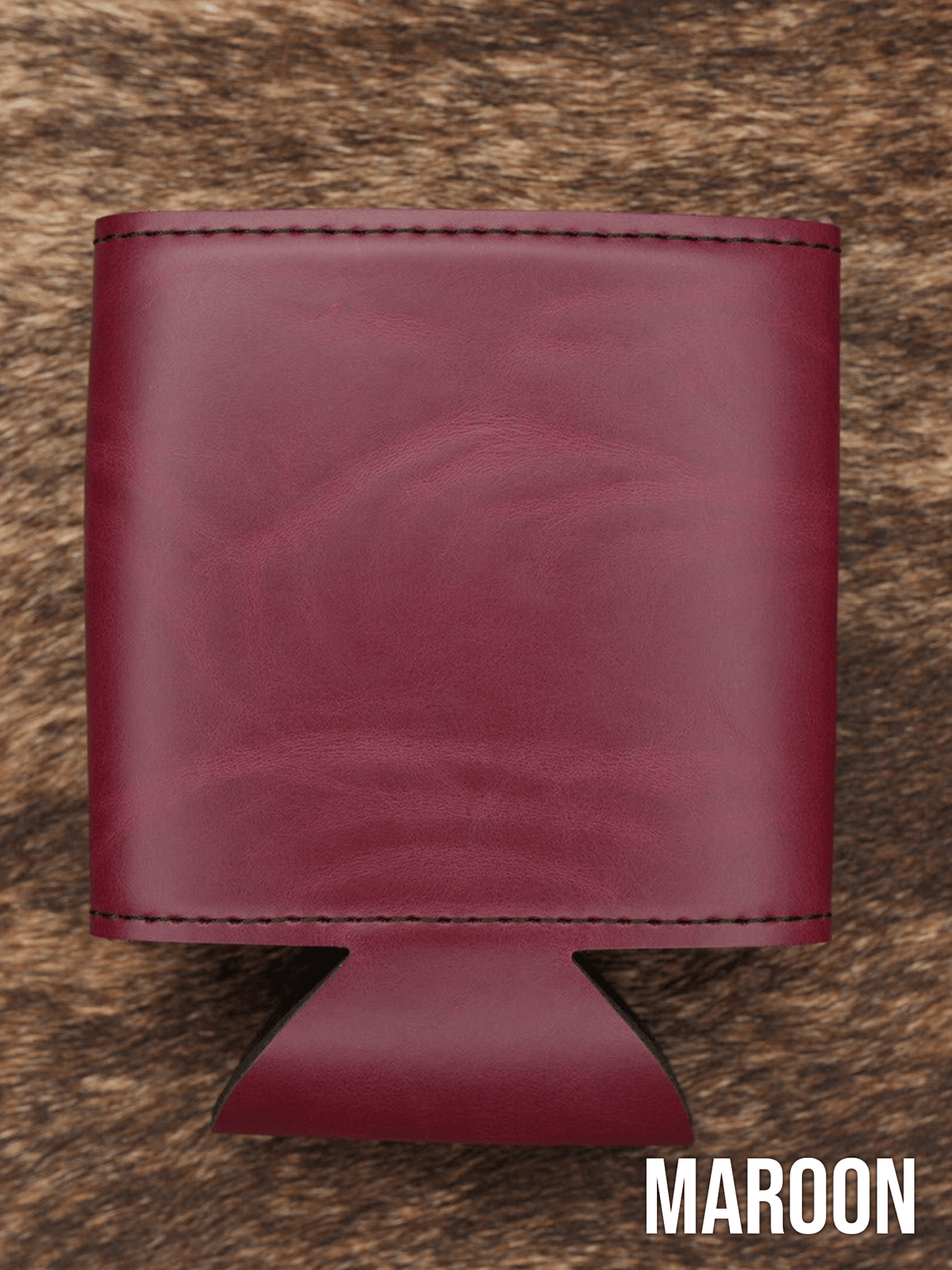 Several Maroon deep red Premium Leatherette can coolers laid flat on weathered wood, shown collapsed.