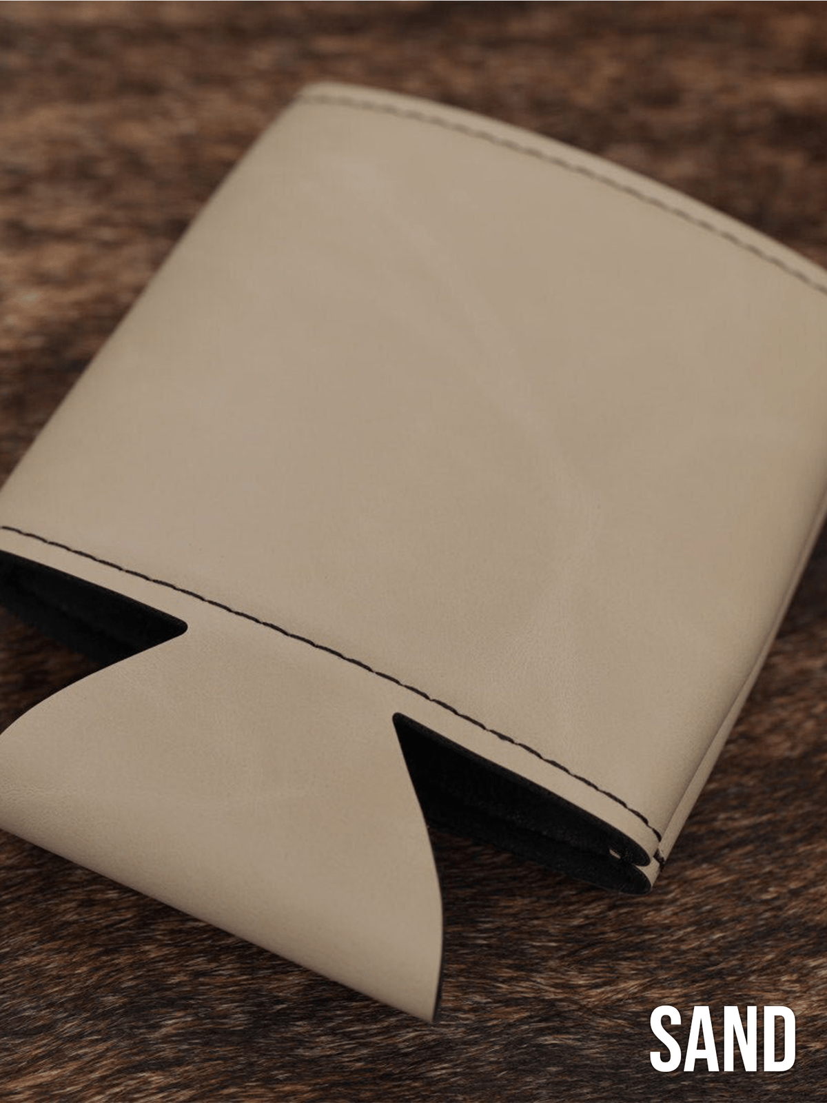 Several Sand beige Premium Leatherette can coolers laid flat on weathered wood, shown collapsed.