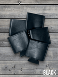 Several Black Premium Leatherette can coolers laid flat on weathered wood, shown collapsed.