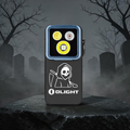 Olight Oclip 2 Pro Skull Hood with a carved hooded reaper, resting on a stone slab in a foggy graveyard