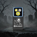 Olight Oclip 2 Pro Skull Hood with a carved hooded reaper, resting on a stone slab in a foggy graveyard