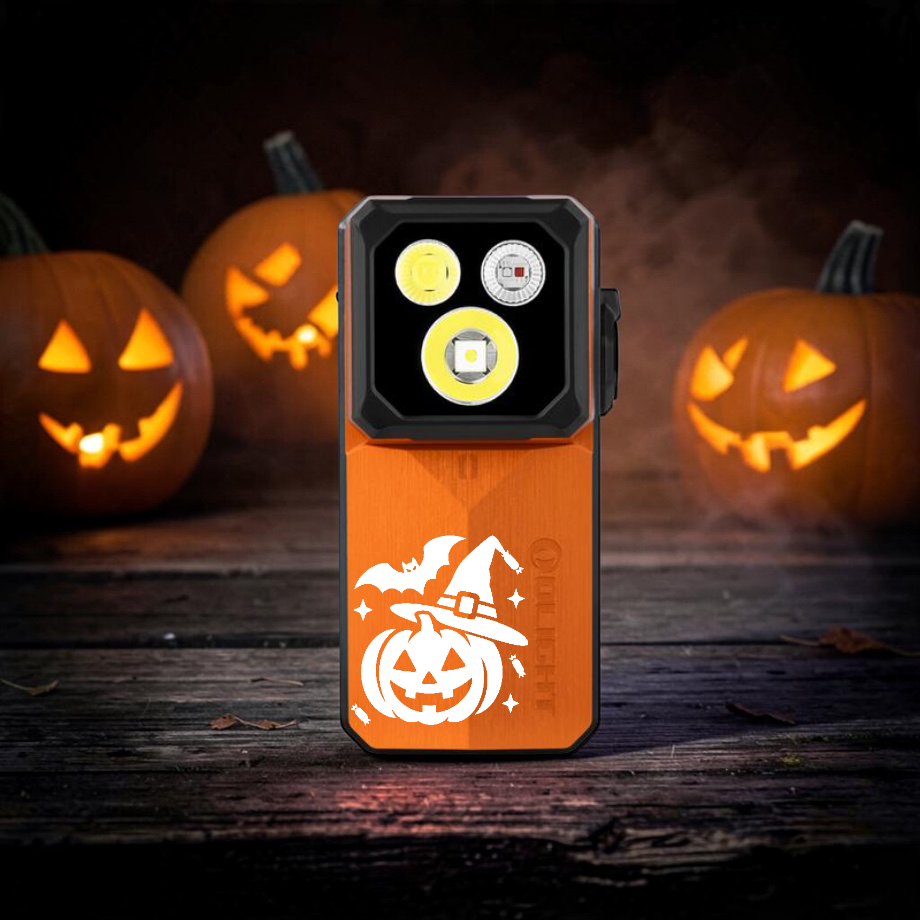 Olight Oclip 2 Ultra Halloween Edition with a carved jack-o'-lantern in a witch hat, on an old wood table between glowing carved pumpkins