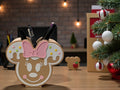 Gingerbread-styled pencil holder with mouse ears and a pink bow, holding pens on a counter