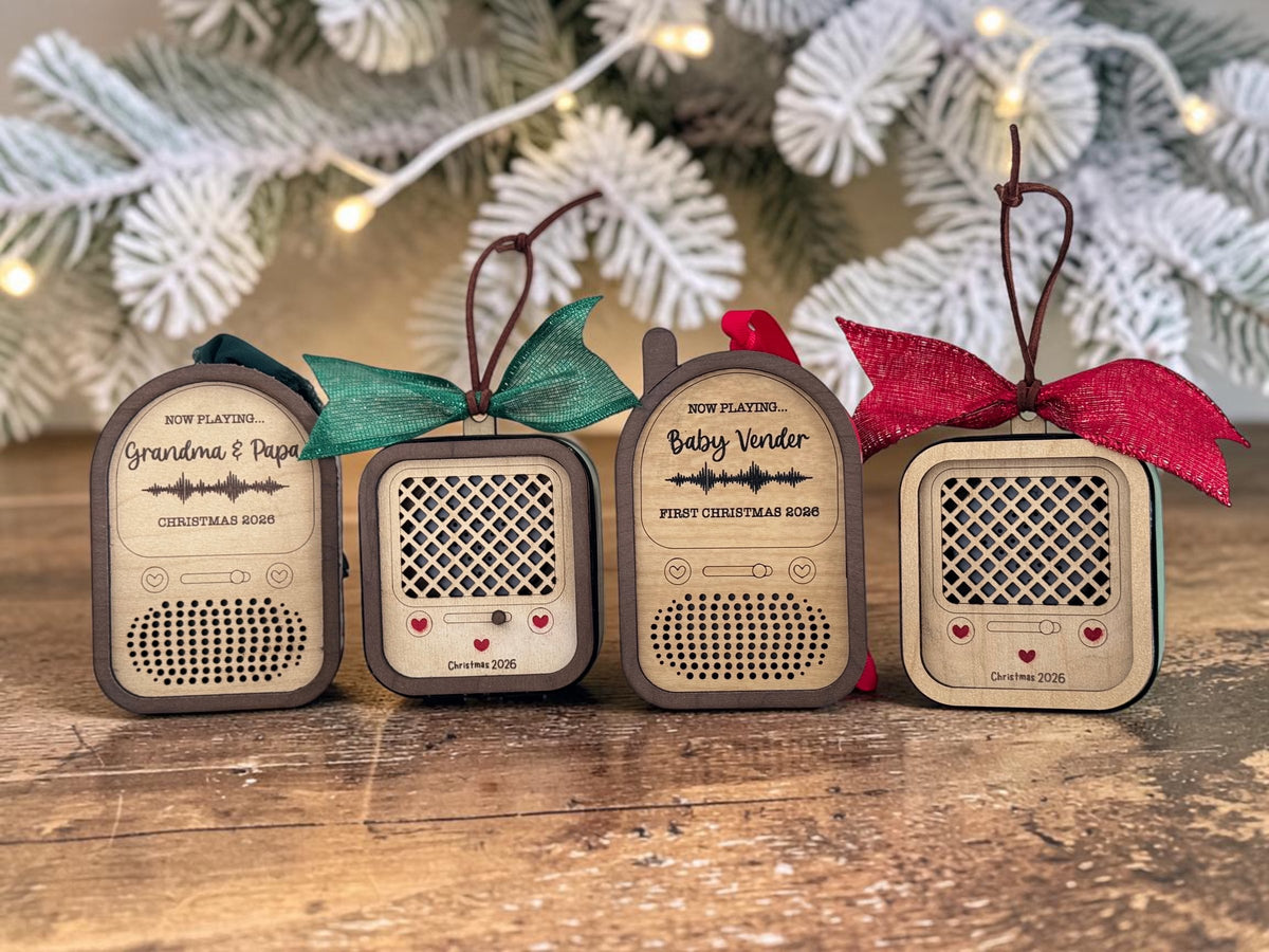 Four recordable voice ornaments in a row: Round Top Radio, Vintage Radio, Baby Monitor and a second Vintage Radio, with holiday bows