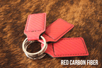 Three red carbon fiber Premium Leatherette keychains with a woven texture, fanned out on a split ring.