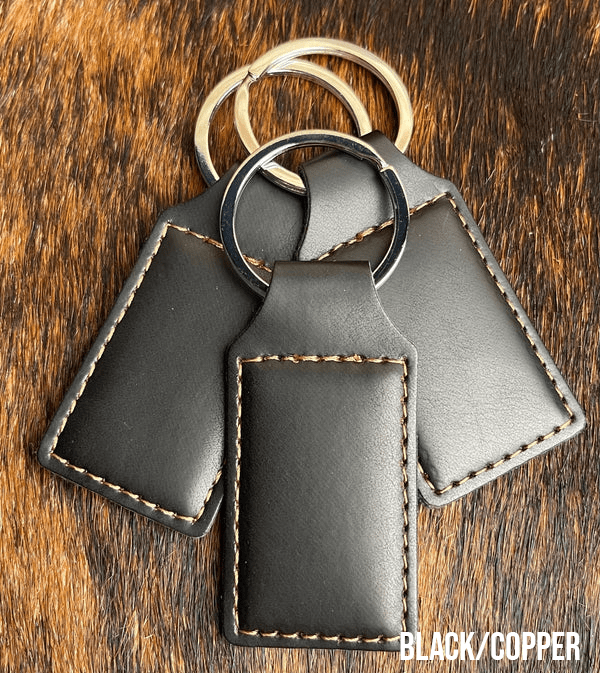 Three black Premium Leatherette keychains that engrave to copper, fanned out on a split ring.