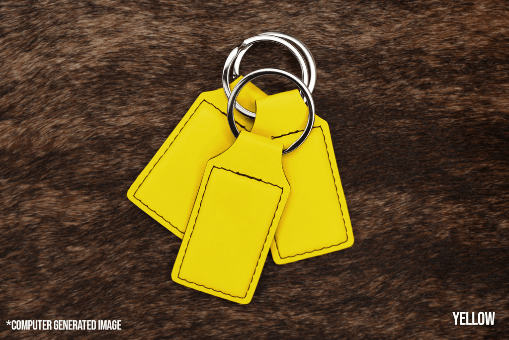 Three Yellow Premium Leatherette keychains fanned out on a split ring, showing the blank engraving panel.
