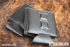 Black and silver Premium Leatherette magnetic can coozie, standard 12 oz. size, shown folded to reveal the built-in magnets
