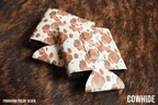 Cowhide print Premium Leatherette magnetic can coozie in brown and white, standard 12 oz. size, shown folded to reveal the built-in magnets