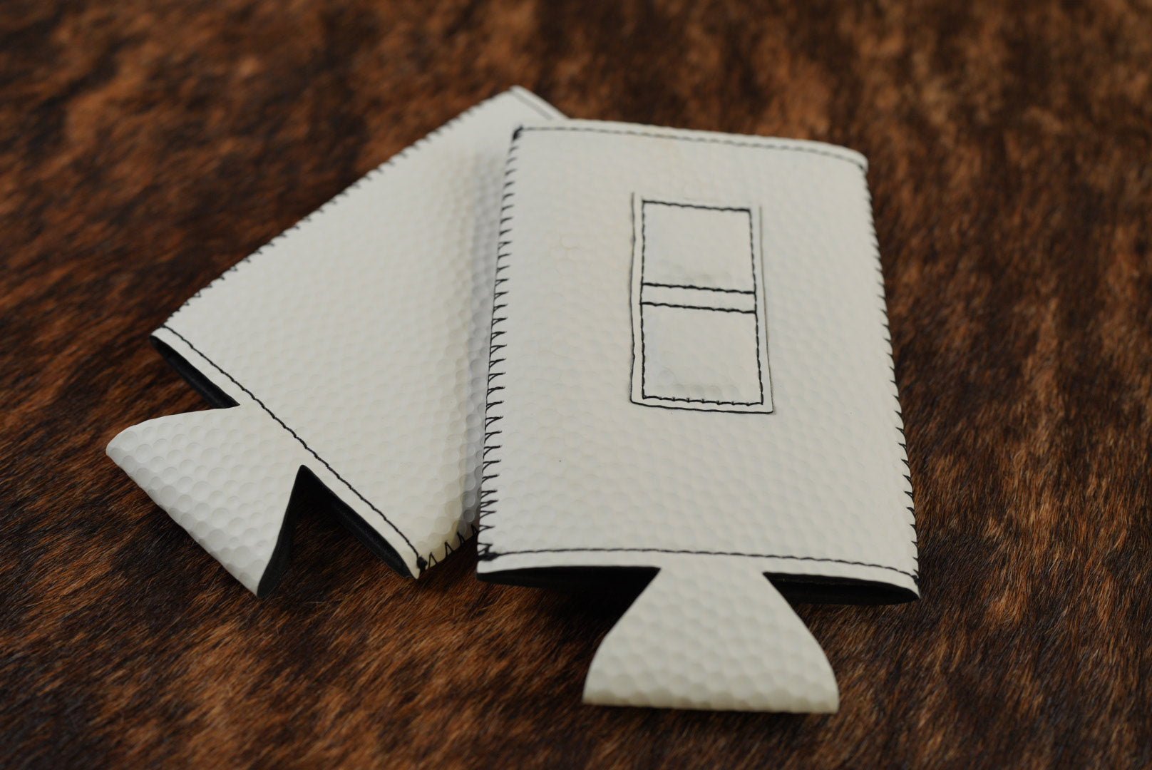 Golf Ball dimpled texture Premium Leatherette magnetic can coozie, slim can size, shown folded to reveal the built-in magnets