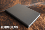 Heritage Black Premium Leatherette journal cover, shown closed on a cowhide surface