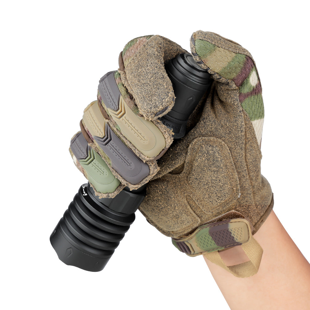 Warrior X 4 held in a gloved hand