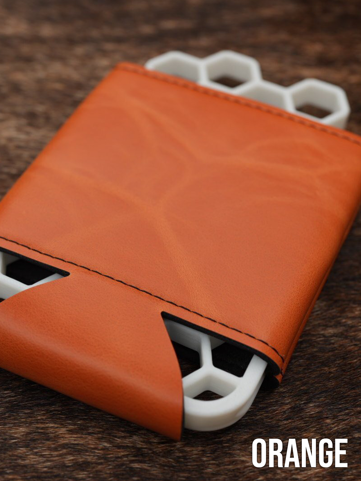 Several burnt orange Premium Leatherette can coolers laid flat on weathered wood, shown collapsed.