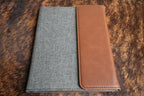 Walnut brown Premium Leatherette padfolio, shown closed on a cowhide surface