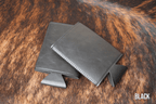 Black Premium Leatherette slim can coolers, sized for slim cans, laid flat and collapsed.