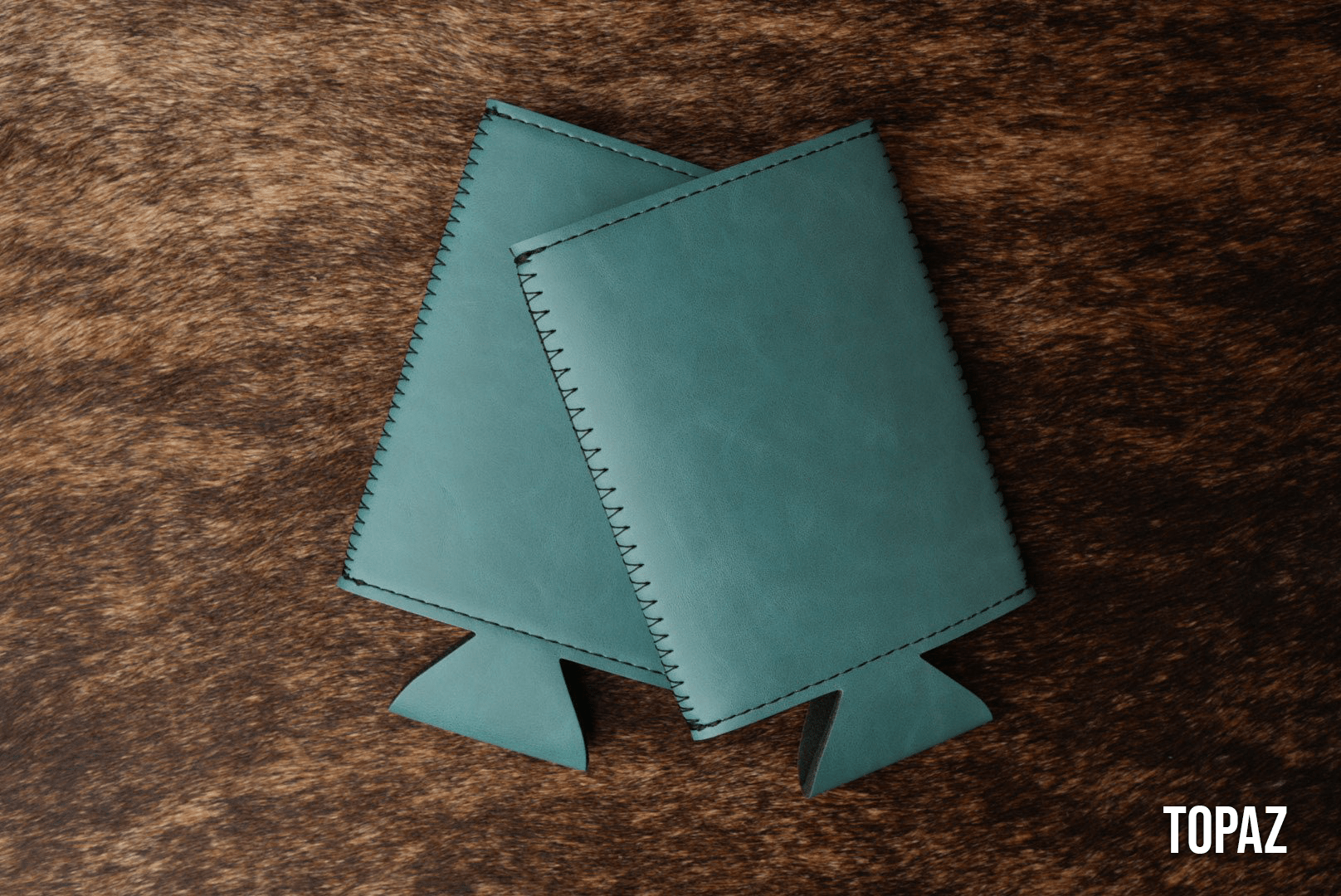 Topaz teal Premium Leatherette slim can coolers, sized for slim cans, laid flat and collapsed.