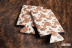 Cowhide print Premium Leatherette slim can coolers in a black and white hide pattern, sized for slim cans.