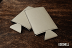 Eggshell cream Premium Leatherette slim can coolers, sized for slim cans, laid flat and collapsed.