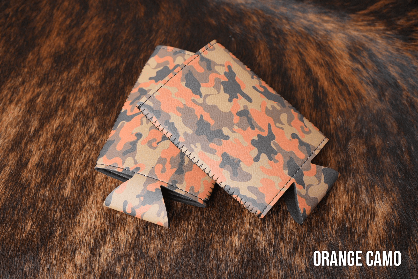 Orange Camo Premium Leatherette slim can coolers in an orange camouflage pattern, sized for slim cans.