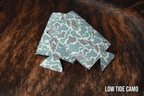 Low Tide Camo Premium Leatherette slim can coolers in a muted camouflage pattern, sized for slim cans.