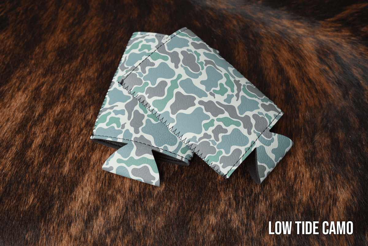 Low Tide Camo Premium Leatherette slim can coolers in a muted camouflage pattern, sized for slim cans.