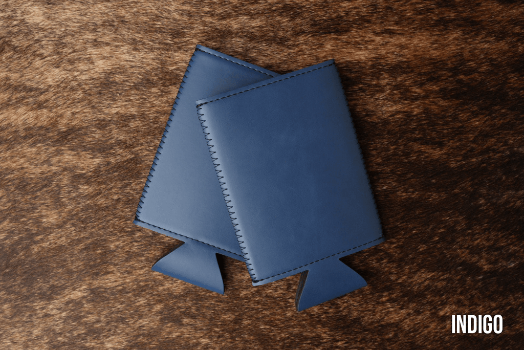 Indigo blue Premium Leatherette slim can coolers, sized for slim cans, laid flat and collapsed.