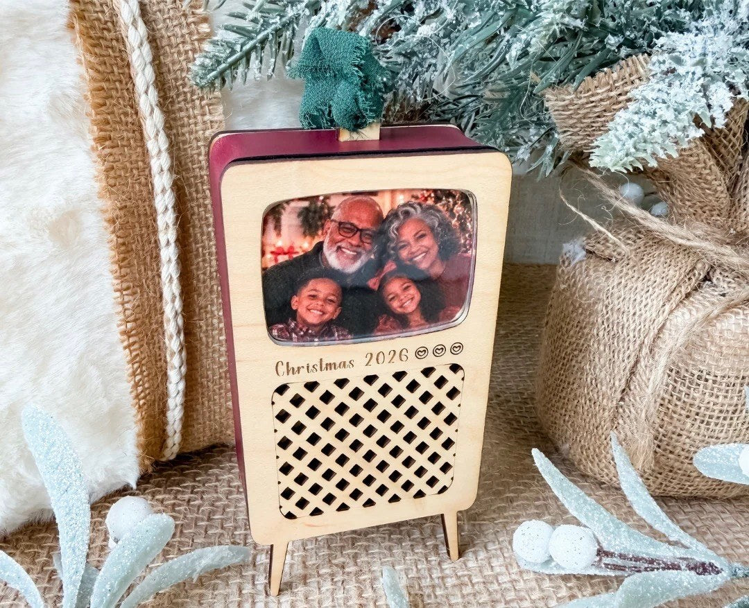 Television ornament with a family photo behind its acrylic window and Christmas 2026 engraved below the screen