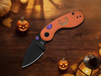 Kizer Microbe Halloween Edition open on a wood table with small pumpkins