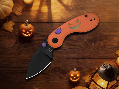Kizer Microbe Halloween Edition open on a wood table with small pumpkins