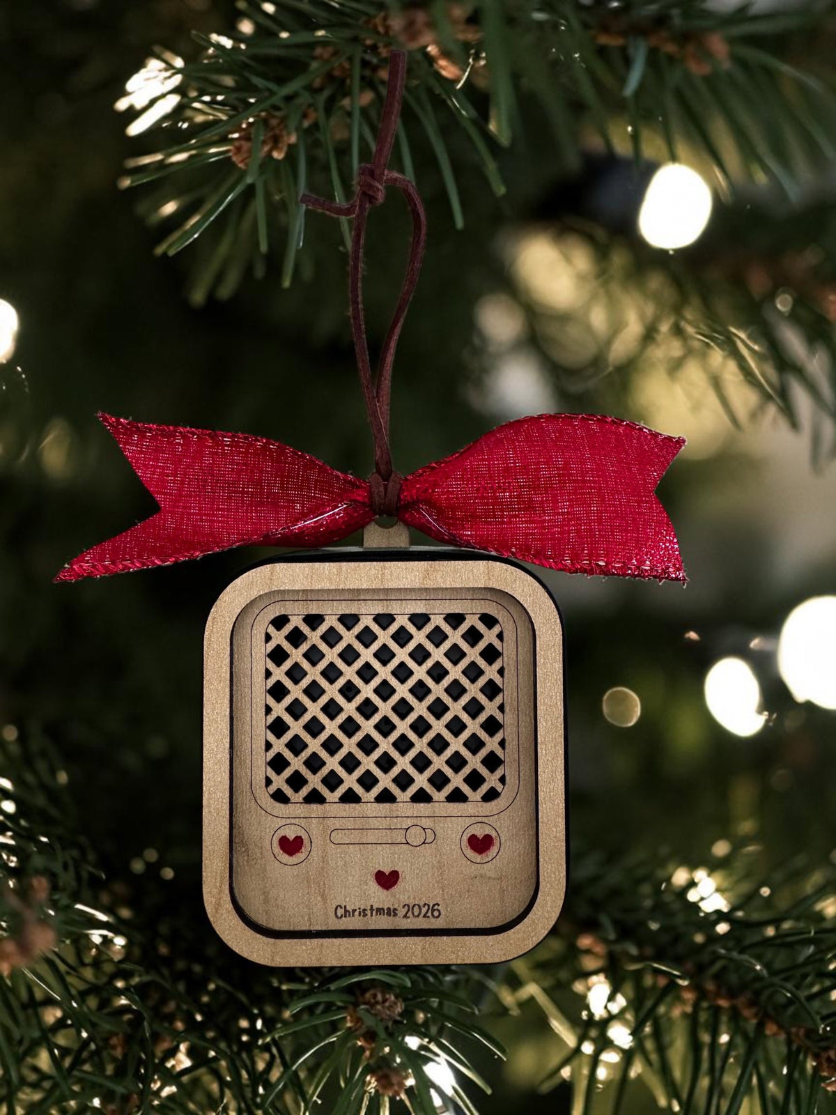 Vintage Radio recordable ornament in natural wood with red hearts and a red bow, hanging on a tree